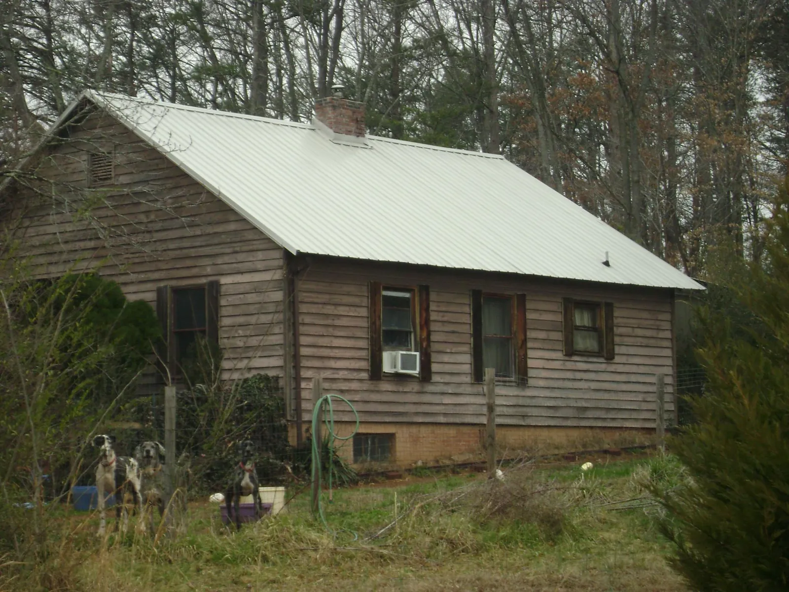 White metal roof on an old wood sided farmhouse, from a Metal Roof Installation job in Jackson Center